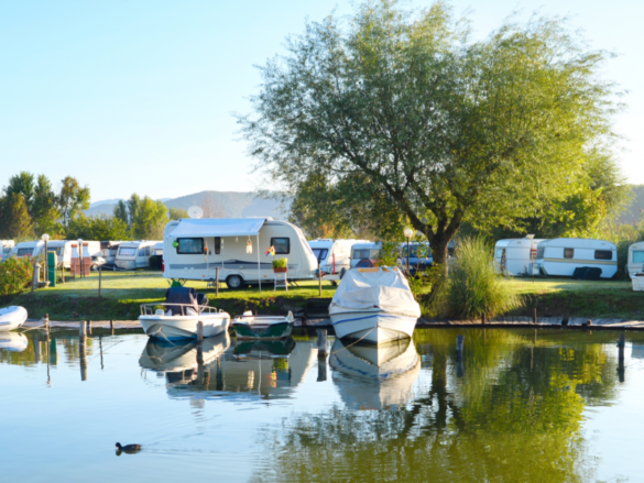 Camping site on a lake with caravans and boats by joyt